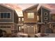 Inviting exterior view of a modern home with a stone facade and a garage, set against a colorful sky at dusk at 9719 Albion Ln, Thornton, CO 80229