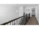 Second floor hallway features dark railings, neutral walls, and chandelier at 9719 Albion Ln, Thornton, CO 80229