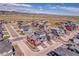 Wide aerial of the neighborhood highlighting this house, landscaping, and mountain views in the distance at 8728 Hotchkiss St, Littleton, CO 80125