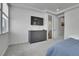 Contemporary bedroom featuring a large dresser, soft carpet, and a mounted TV at 8728 Hotchkiss St, Littleton, CO 80125