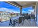 Inviting covered patio features a dining table and grill, perfect for outdoor entertaining at 8728 Hotchkiss St, Littleton, CO 80125