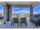 Relaxing covered patio features a dining table set with scenic neighborhood views at 8728 Hotchkiss St, Littleton, CO 80125