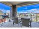 Inviting covered patio with dining table and chairs overlooks the neighborhood at 8728 Hotchkiss St, Littleton, CO 80125