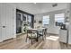 Stylish dining area with hardwood floors, modern table set and built-in shelves at 8728 Hotchkiss St, Littleton, CO 80125