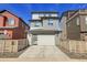 Contemporary home with a well-manicured front yard and attached garage at 8728 Hotchkiss St, Littleton, CO 80125