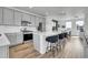 Modern kitchen features gray cabinets, stainless steel appliances, a quartz countertop island, and hardwood floors at 8728 Hotchkiss St, Littleton, CO 80125