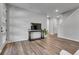 Open living room with sleek hardwood floors, a stylish console table, and abundant natural light at 8728 Hotchkiss St, Littleton, CO 80125
