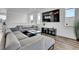 Bright living room with comfortable gray sofa, TV, lots of windows offering great natural light at 8728 Hotchkiss St, Littleton, CO 80125