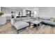 Open floor plan showcasing the living room and kitchen featuring lots of windows, recessed lighting, and hardwood floors at 8728 Hotchkiss St, Littleton, CO 80125