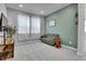 Inviting living room with a comfy sofa, soft carpet, and a large window for natural light at 8728 Hotchkiss St, Littleton, CO 80125