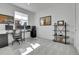 Well-lit home office with a large window, computer setup, and shelving for organized productivity at 8728 Hotchkiss St, Littleton, CO 80125
