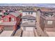 View of the rear exterior featuring a garage with modern design, privacy fence, and mountain views in the distance at 8728 Hotchkiss St, Littleton, CO 80125