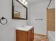 Bathroom featuring a vanity, mirror, and a shower-tub combo with tiled walls at 3300 W Florida Ave # 26, Denver, CO 80219