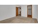 Bedroom featuring carpet flooring, closet and an open doorway with stairs visible in the background at 3300 W Florida Ave # 26, Denver, CO 80219