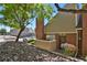Charming brick townhouse with a well-maintained front yard and mature landscaping at 3300 W Florida Ave # 26, Denver, CO 80219