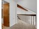 Hallway with carpet flooring and wood railing at 3300 W Florida Ave # 26, Denver, CO 80219