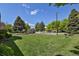 Community playground with slide, picnic table, and basketball court at 3300 W Florida Ave # 26, Denver, CO 80219