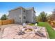 Backyard featuring stone patio with a fire pit and Adirondack chairs, perfect for outdoor entertaining and relaxation at 11921 S Black Horn Cir, Parker, CO 80134