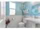 Elegant bathroom with blue walls, wainscoting, a pedestal sink, and decorative accents at 11921 S Black Horn Cir, Parker, CO 80134