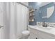 Stylish bathroom features a modern vanity, round mirror, and sleek shelving at 11921 S Black Horn Cir, Parker, CO 80134