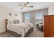 Inviting bedroom with neutral tones, ceiling fan, and ample natural light at 11921 S Black Horn Cir, Parker, CO 80134