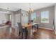 Cozy dining room with hardwood floors, chandelier lighting, gray walls, and large windows for ample natural light at 11921 S Black Horn Cir, Parker, CO 80134