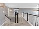 Bright hallway featuring neutral carpet, white banisters, and stylish lighting fixtures at 11921 S Black Horn Cir, Parker, CO 80134