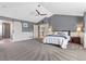 Large primary bedroom featuring neutral walls, a vaulted ceiling, and an ensuite bathroom entrance at 11921 S Black Horn Cir, Parker, CO 80134