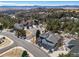 Aerial view of a neighborhood showcasing mountain views and mature trees at 7515 Pineridge Trl, Castle Pines, CO 80108