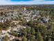 An aerial view of a sprawling neighborhood nestled amongst trees and a large golf course at 7515 Pineridge Trl, Castle Pines, CO 80108