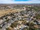 Aerial view of a large planned community featuring lush green landscaping and a golf course at 7515 Pineridge Trl, Castle Pines, CO 80108