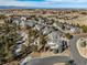 A bird's eye view of a community featuring well-kept lawns and tree-lined streets at 7515 Pineridge Trl, Castle Pines, CO 80108