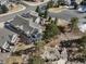 Aerial view of a home with a landscaped yard, set in a neighborhood with mature trees at 7515 Pineridge Trl, Castle Pines, CO 80108