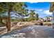 Backyard view with a deck overlooking trees, a stone outcrop, and nearby homes at 7515 Pineridge Trl, Castle Pines, CO 80108