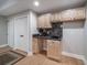 A basement wet bar with a sink and cabinets and a doorway to a closet at 7515 Pineridge Trl, Castle Pines, CO 80108