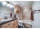 Bathroom featuring wood cabinets with a marble countertop, a shower, and modern lighting at 7515 Pineridge Trl, Castle Pines, CO 80108