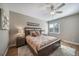 Comfortable bedroom featuring a bed with a ceiling fan and bedside tables at 7515 Pineridge Trl, Castle Pines, CO 80108