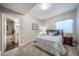 Comfortable bedroom with cozy carpet, a bed with decorative pillows, and a window with natural light at 7515 Pineridge Trl, Castle Pines, CO 80108