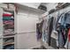 Walk-in closet featuring organized shelving and hanging storage space for clothes and accessories at 7515 Pineridge Trl, Castle Pines, CO 80108