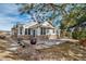 Home exterior with stone accents, an awning, and a well-maintained yard with mature trees at 7515 Pineridge Trl, Castle Pines, CO 80108