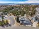 Stunning two-story home with attached garage nestled amongst pine trees and mountain views at 7515 Pineridge Trl, Castle Pines, CO 80108