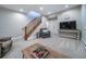 Finished basement with a large sectional, stairs, TV and carpeting at 7515 Pineridge Trl, Castle Pines, CO 80108