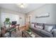 Inviting living room features a gray couch, hardwood floors, a desk, and bright lighting at 7515 Pineridge Trl, Castle Pines, CO 80108