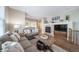 Comfortable living room with a fireplace, hardwood floors, and neutral decor at 7515 Pineridge Trl, Castle Pines, CO 80108