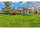 Spacious backyard with a patio, an upper balcony, and plenty of lush green grass at 387 Upham St, Lakewood, CO 80226