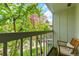 Balcony view framed by lush greenery and a rocking chair for outdoor relaxation at 387 Upham St, Lakewood, CO 80226