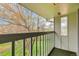 View from covered balcony, overlooking trees and green space at 387 Upham St, Lakewood, CO 80226