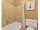 Bathroom featuring tile walls around the tub and a floral shower curtain at 387 Upham St, Lakewood, CO 80226