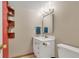 Compact bathroom featuring modern vanity, wall-mounted mirror, and neutral color palette at 387 Upham St, Lakewood, CO 80226