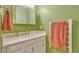 Bathroom featuring a white vanity and countertop, complemented by a decorative mirror and lighting at 387 Upham St, Lakewood, CO 80226
